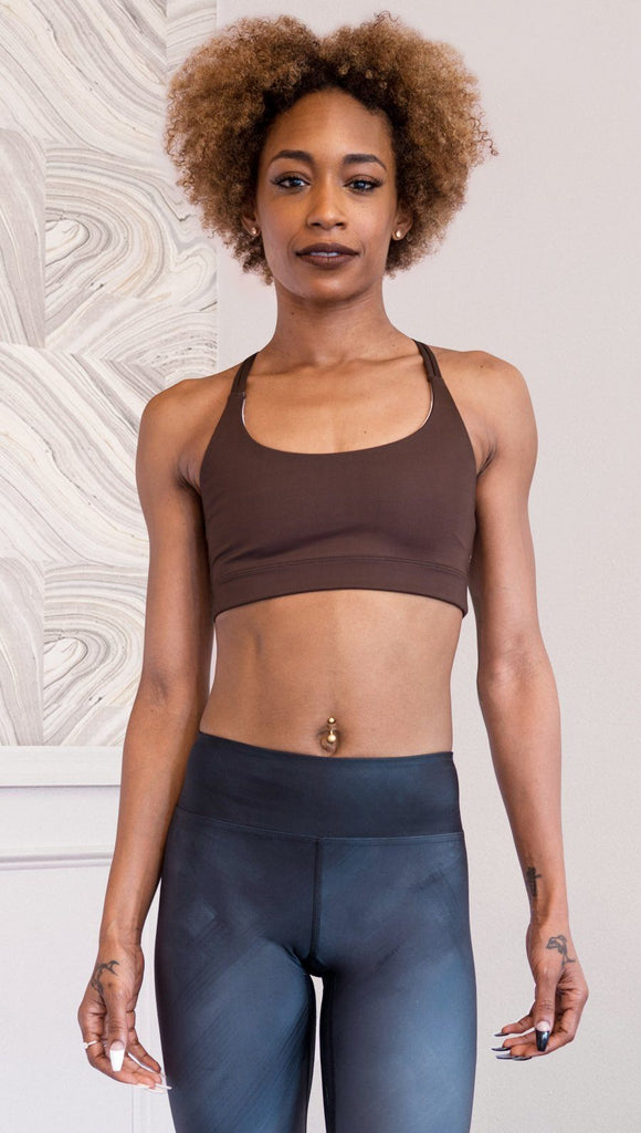 front view of model wearing nude / mocha tone sports bra