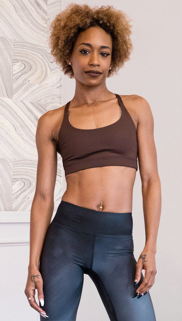 front view of model wearing nude / mocha tone sports bra