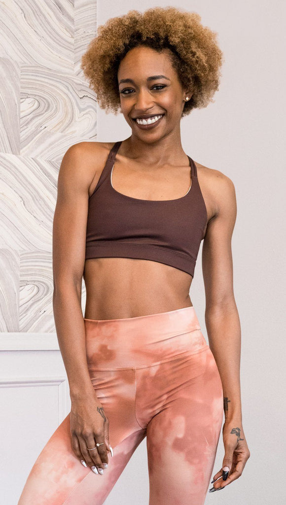 front view of model wearing nude / mocha tone sports bra