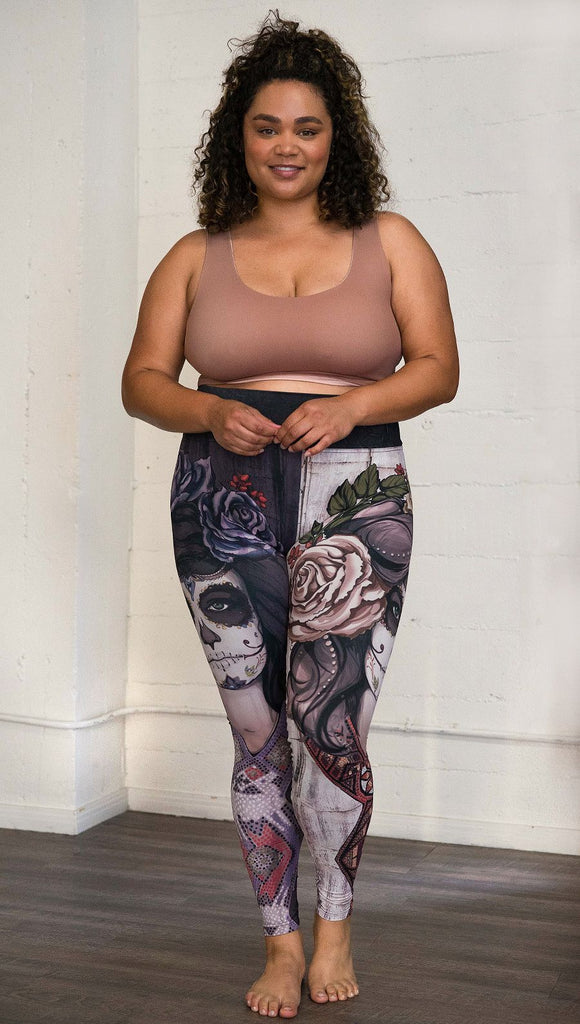 front view of model wearing mashup Sugar Skull and Dia De Los Muertos themed printed full length leggings