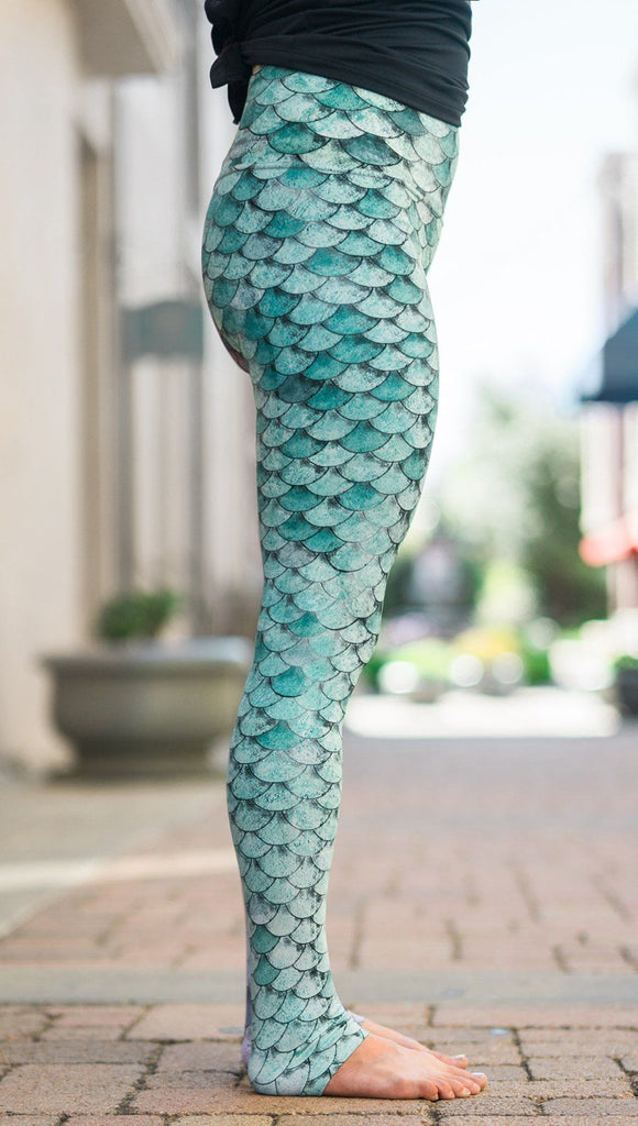 closeup right side view of model wearing mermaid scales design printed full length leggings