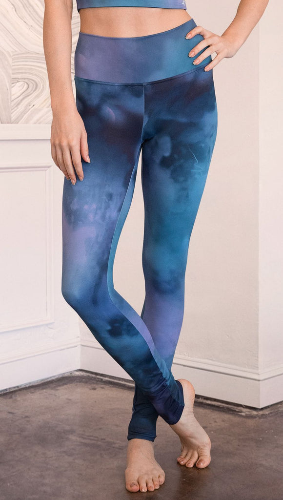 closeup front view of model wearing full length leggings with tanzanite watercolor printed design