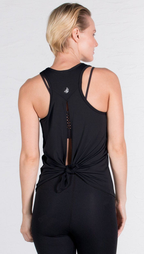 closeup back view of model wearing black tie back sports tank top