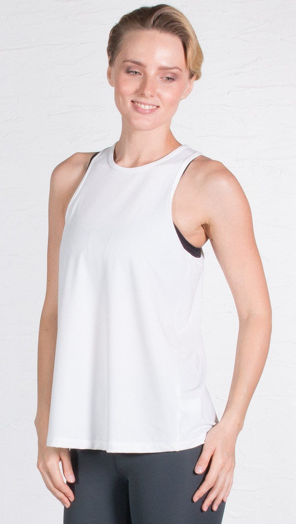 closeup front view of model wearing white tie back sports tank top