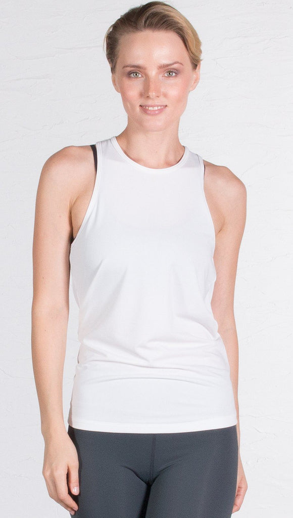 closeup front view of model wearing white tie back sports tank top