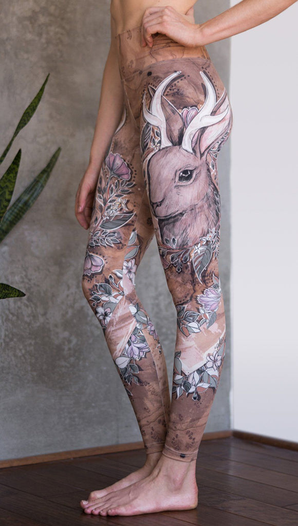 closeup left side view of model wearing full length leggings with printed jackalope design