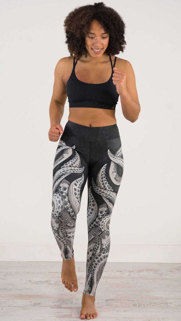 Front full body view of model wearing WEKSHOP Tentacles Full Length Triathlon Leggings. The artwork is monochrome black and white and features large tentacles wrapping around the legs from the bottom reaching upward.