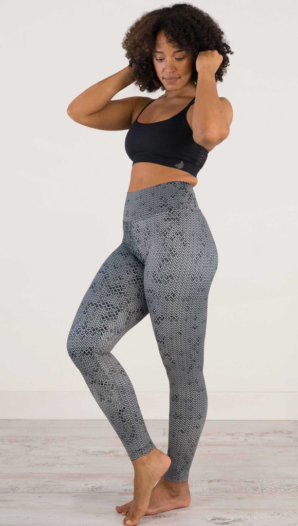 Full body side view of model wearing WERKSHOP Chainmaille Athleisure Leggings. The leggings are printed with a photo-real image of actual chainmaille. Perfect for a Renaissance Festival.