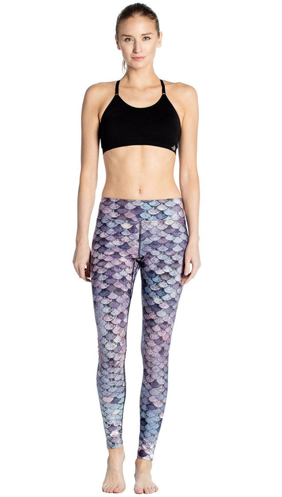 front view of model wearing purple mermaid scale themed printed full length leggings