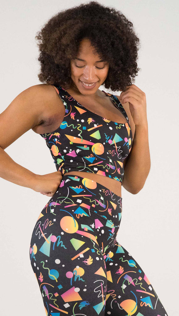 Front view of model wearing WERKSHOP Black and White Confetti Top ... with multi-colored confetti  over a black background on one side and over a white background on the other side. 