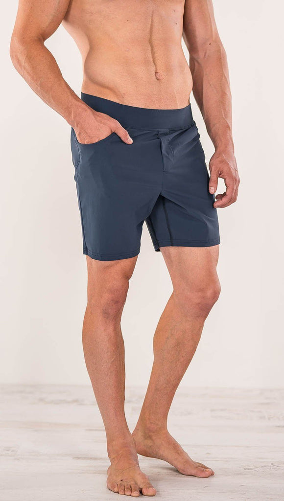 Close up left side view of model wearing black men's performance shorts