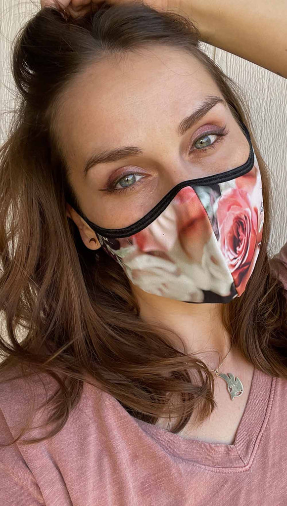 Girl wearing bodacious bouquet adjustable face mask - with soft cream, peach and warm pink roses