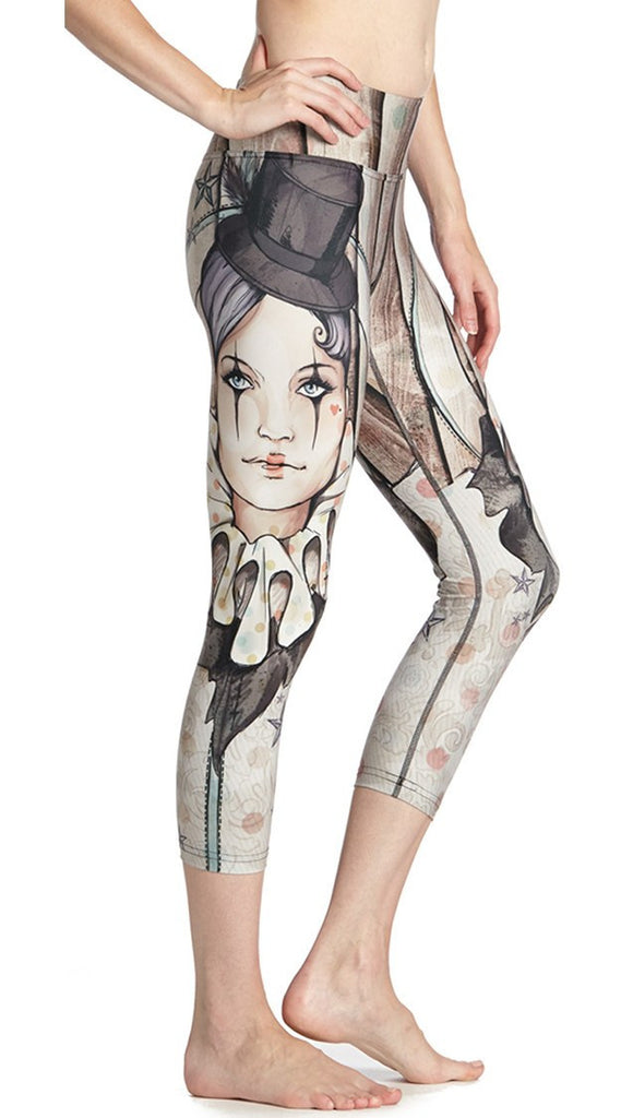 close up side view of model wearing circus girl themed printed capri leggings