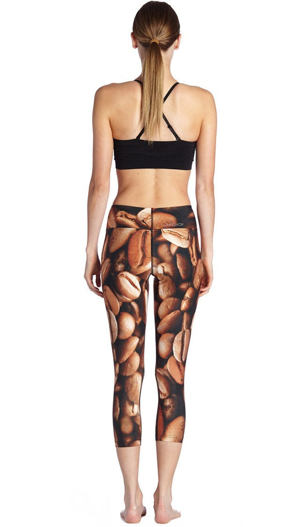 back view of model wearing coffee bean themed printed capri leggings