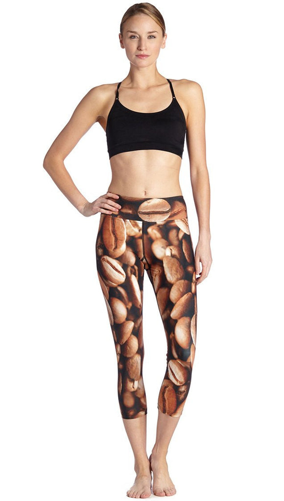 front view of model wearing coffee bean themed printed capri leggings