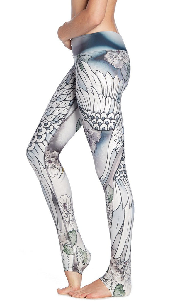 close up left side view of model wearing flying crane themed printed full length leggings