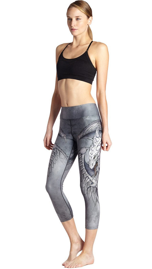 front view of model wearing fantasy dragon themed printed capri leggings