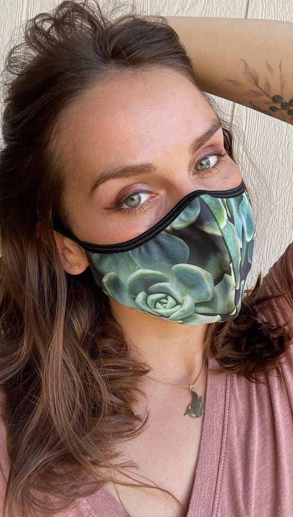 Girl wearing adjustable face mask with green envy succulent-inspired print