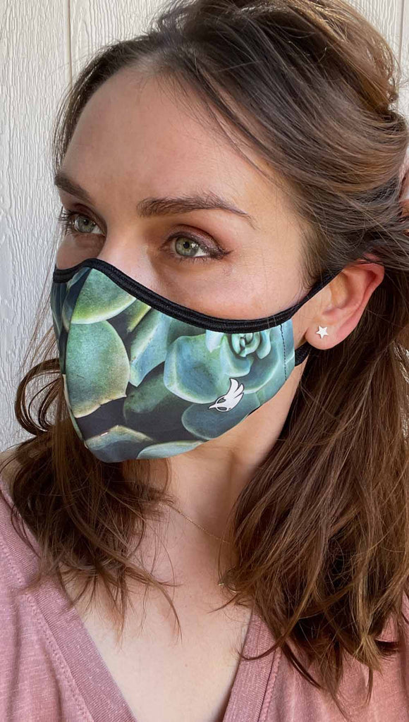 Girl wearing adjustable face mask with green envy succulent-inspired print