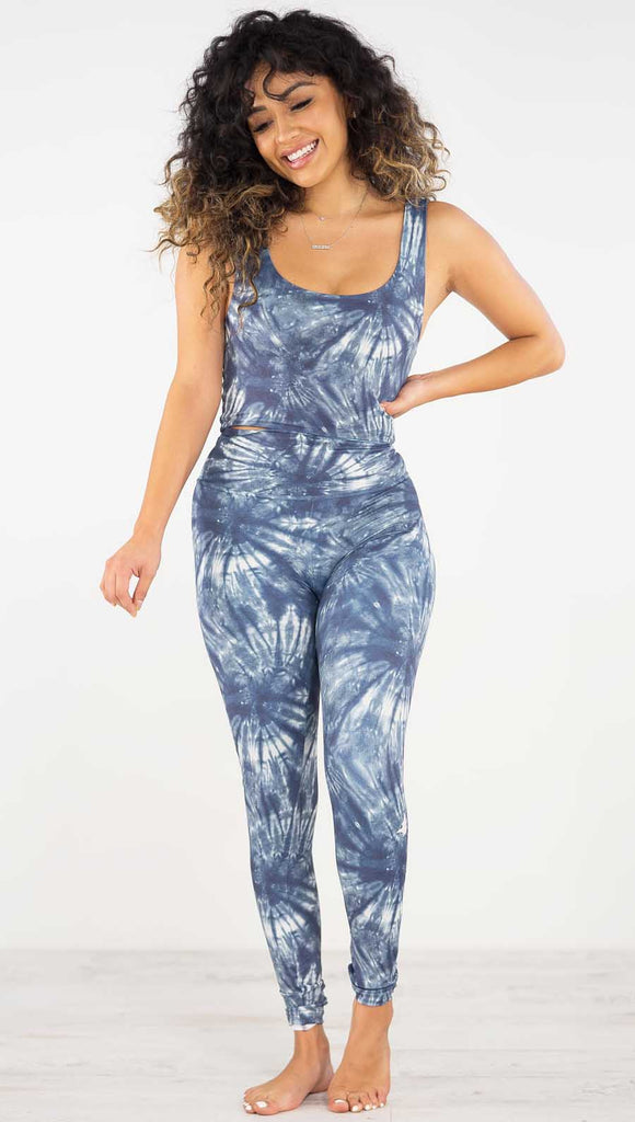 Front view of model wearing the indigo spiral athleisure leggings. They are in a indigo color and have white tie dye spirals throughout the leggings.