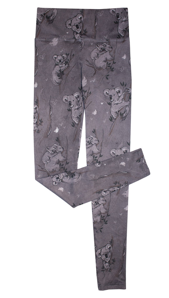 Koala leggings with tree branches and leaves on top of white background