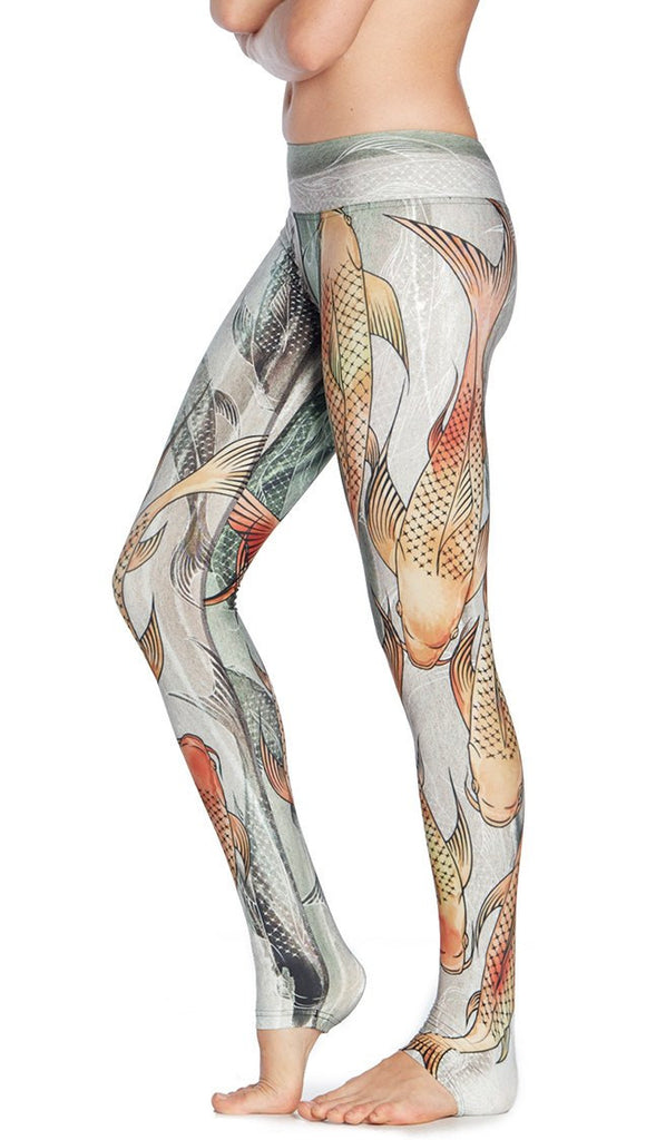 close up left side view of model wearing koi fish themed printed full length leggings