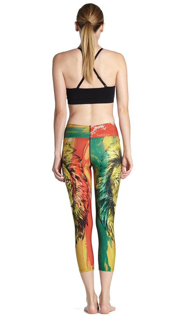 close up back view of model wearing rasta lion themed printed capri leggings