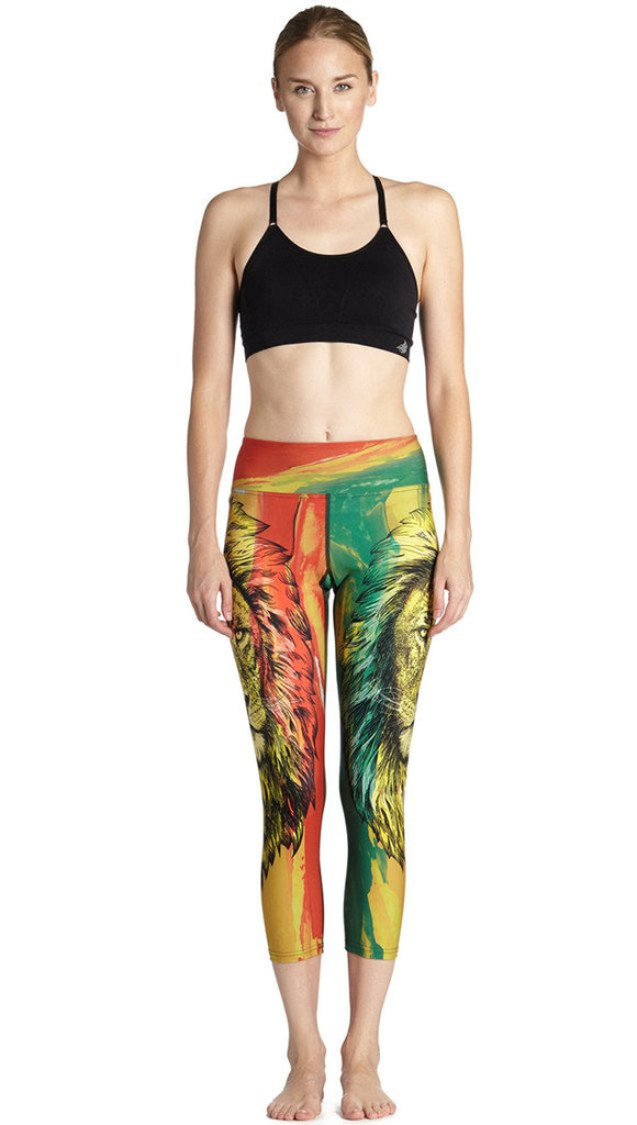 front view of model wearing rasta lion themed printed capri leggings