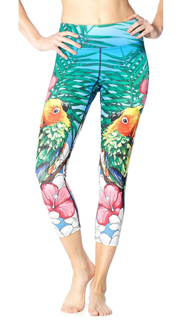 close up front view of model wearing lovebird themed printed capri leggings