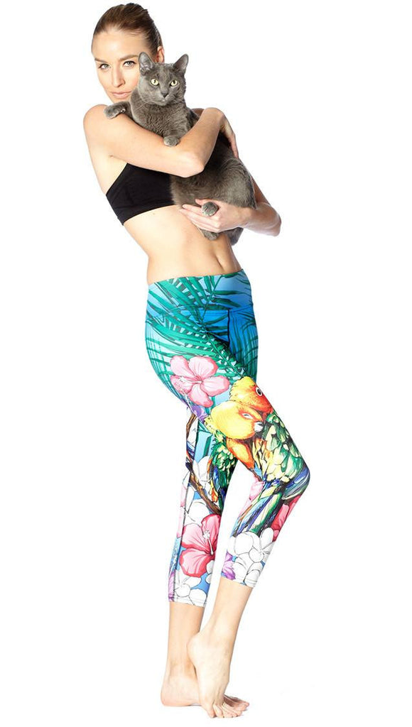 front view of model wearing lovebird themed printed capri leggings