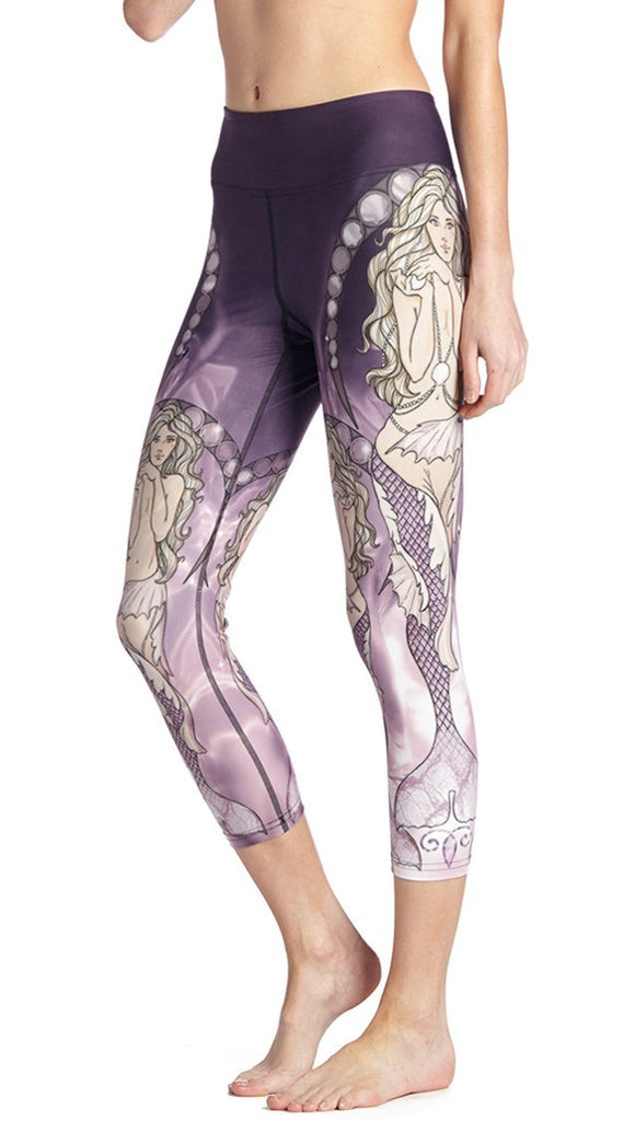 close up side view of model wearing mermaid themed printed capri leggings