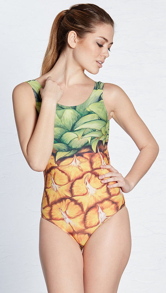 closeup front view of model wearing pineapple themed one piece swimsuit / leotard 