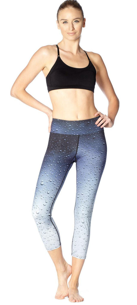 front view of model wearing rain themed printed capri leggings