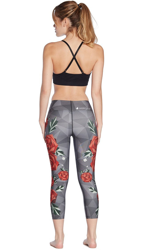 back view of model wearing geometric roses themed printed capri leggings