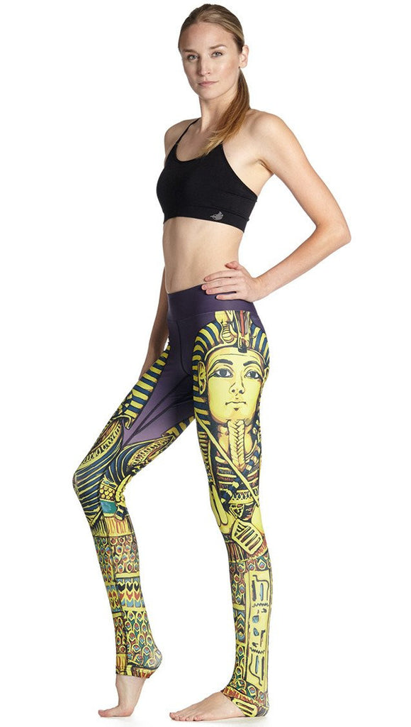 left side view of model wearing king tut themed printed full length leggings