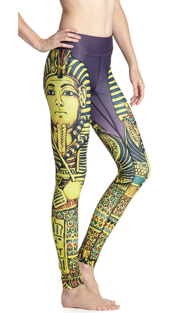 close up side view of model wearing king tut themed printed full length leggings