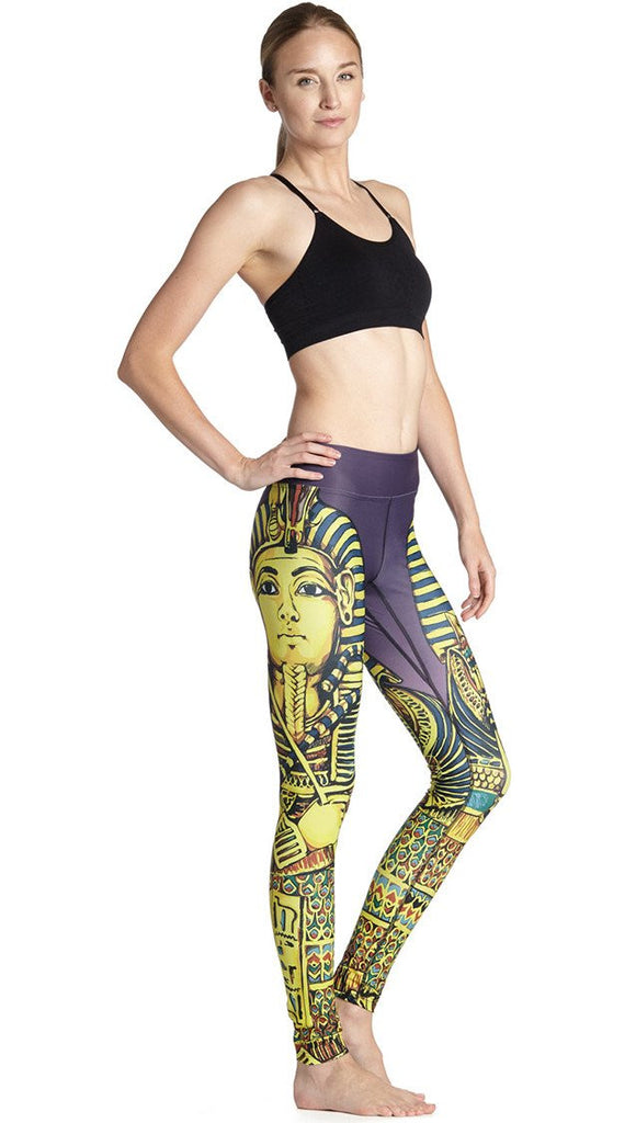 right side view of model wearing king tut themed printed full length leggings